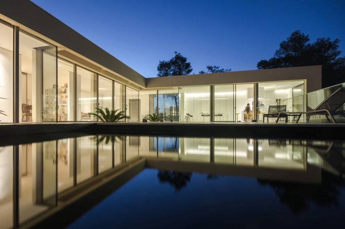 Large windows and a pool to the front.
