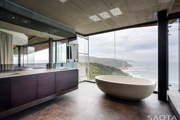 The beautiful bathroom interior design with large windows from the ceiling to the floor.