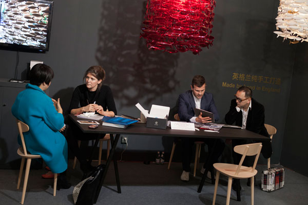 Designers in dialogue with guest of the show or potential clients.