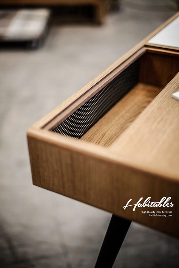 The compartments on the top of the table provide additional storage space.