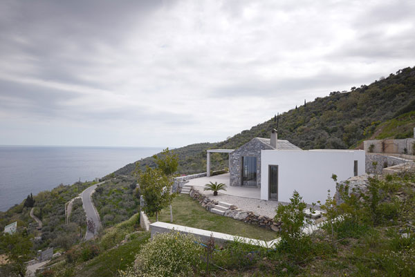 The house is situated at a predestined hillside overlooking the sea at the coast of Tyros, Greece.
