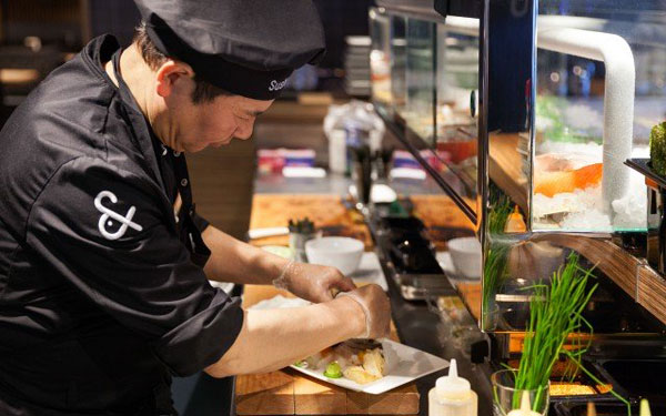 The sushi chef at the delicate preparation.