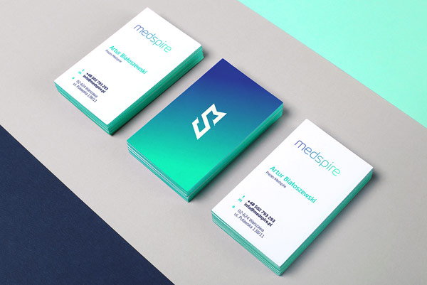 The two-sided business cards with a striking color gradient from blue to turquoise.