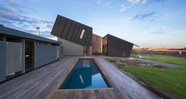 The house with outdoor atrium, pool, and fire place.