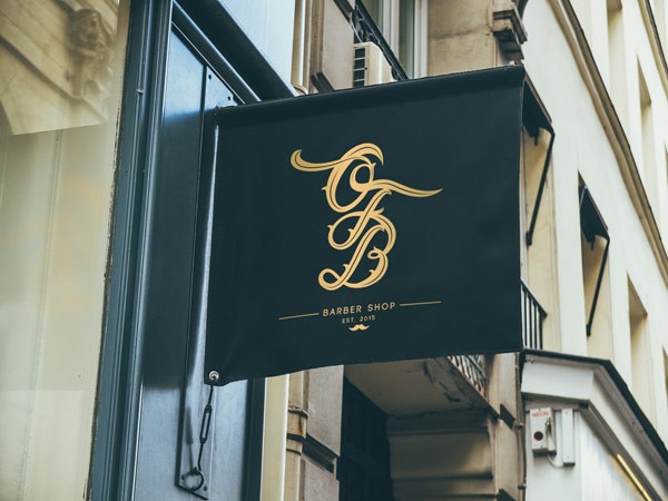 Signage design with custom monogram in golden letters.