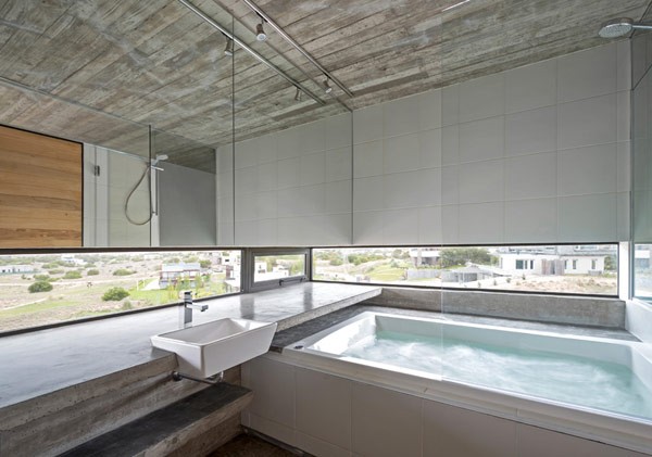 What a beautiful bathroom with great views the surrounding area.