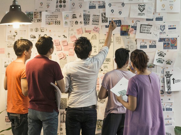 Brainstorming, the creative team has a meeting to discuss ideas and early design concepts.