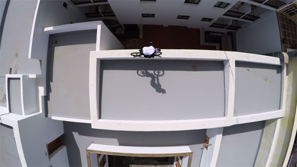 Danny MacAskill balances on an edge of a rooftop.