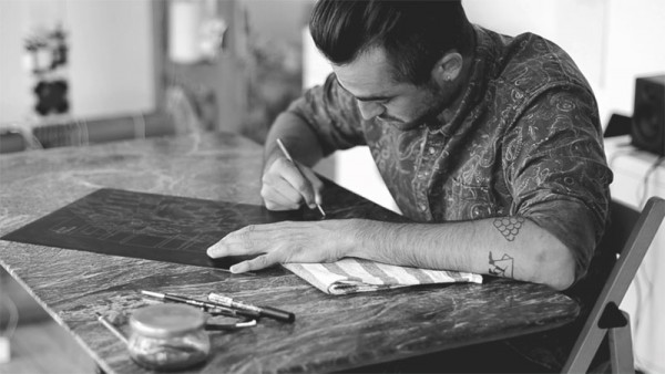 Artist and illustrator Ugo Gattoni at the work of his drypoint etching Sybille's Bath.