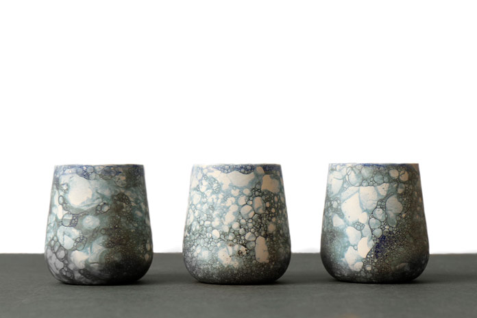 The collection includes a variety of vases in different shapes and sizes like these little cups.