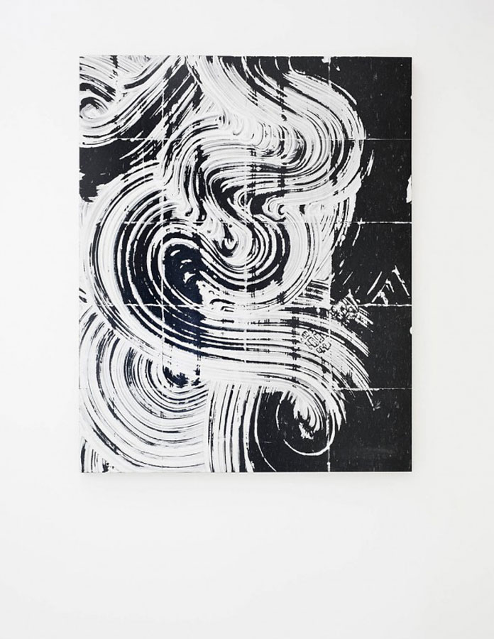 Rough brush tracks in black and white on a tile pattern.