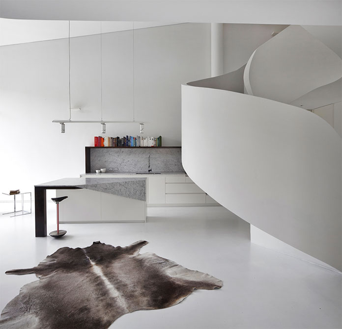The view towards the kitchen space. The curved staircase is to the right. The view towards the kitchen space. The curved staircase is to the right.