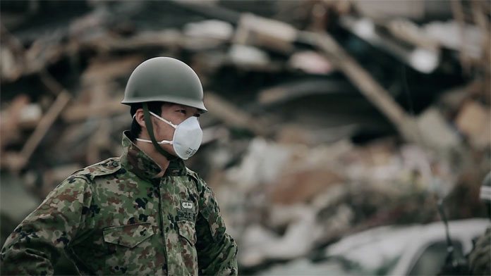 A Japanese soldier stands there almost stunned, struggling with the emotions.