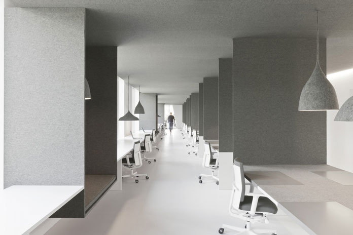 Another view along the open office with numerous workspaces.