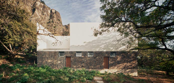 The wall combines rough stones and a smooth white surface.
