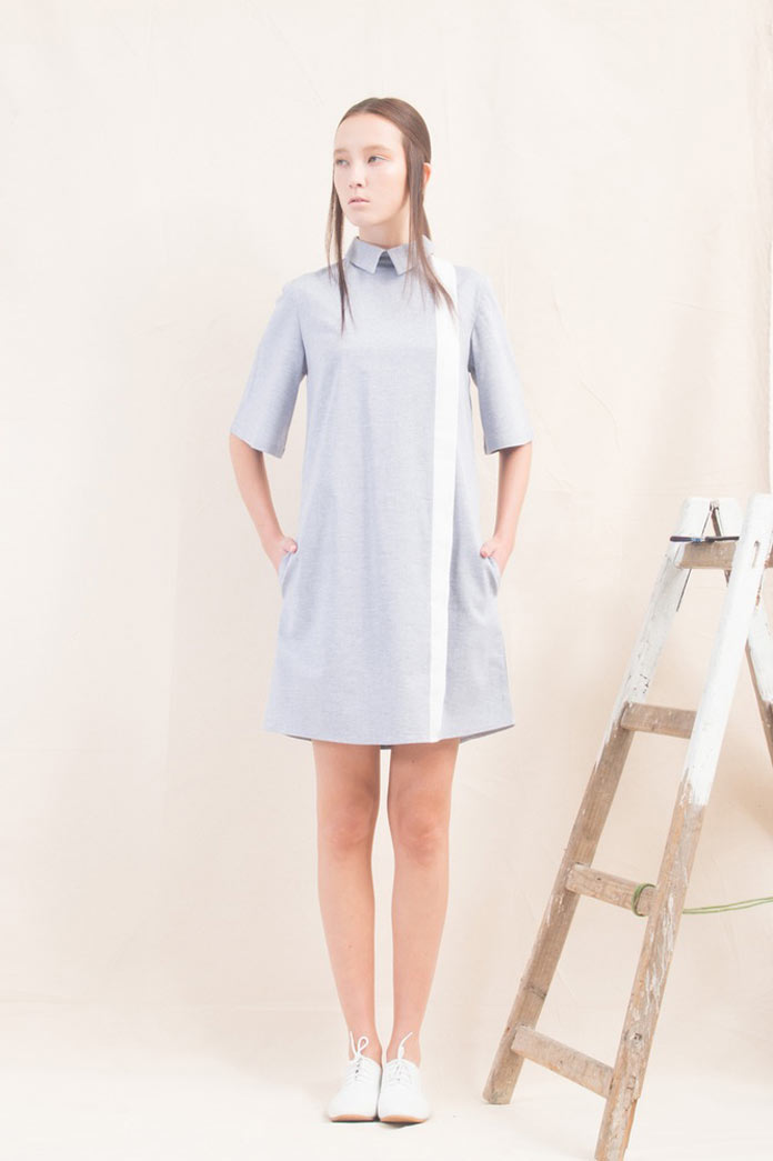 Back zipper opening, front contrasting placket, side pockets, enlarged sleeves.