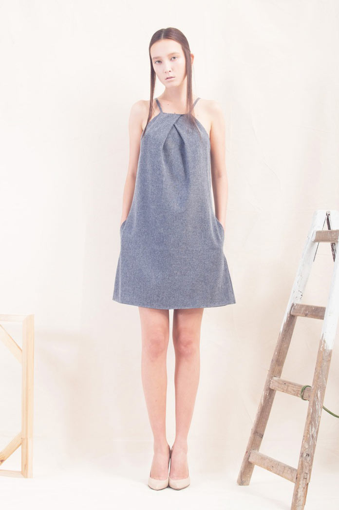 Dress with overlapping pleats, geometric arm-hole and neckline, side pockets.