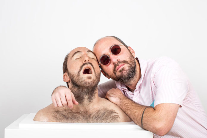 Artist Luigi Rodriguez and the sculpture of his own head.