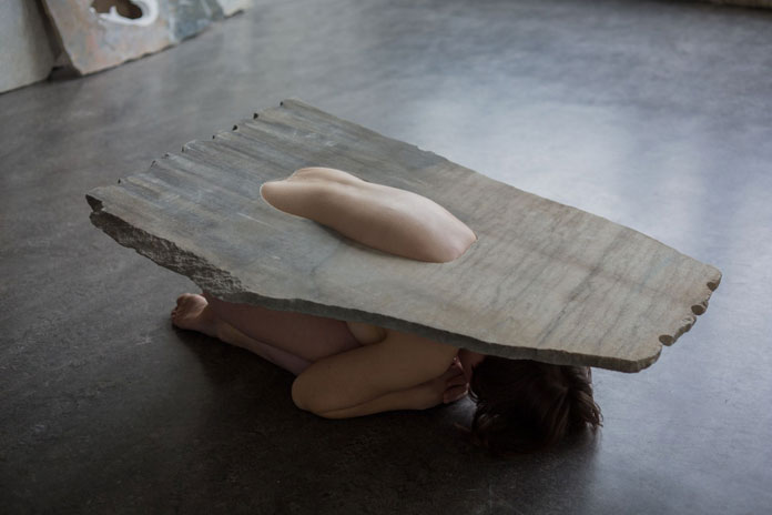 The marble sheets act like frames for the body.