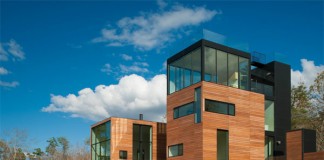 Cubic design with wood and glass facades.