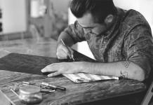 Artist and illustrator Ugo Gattoni at the work of his drypoint etching Sybille's Bath.