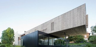 Three volumes contain a different program inside and outside. They sit on top of each other to form this house in Sèvres, France.